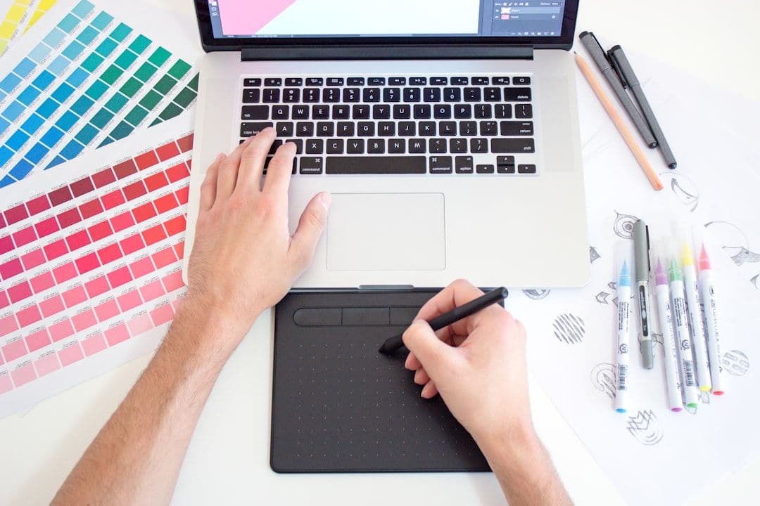 Creative professional reviewing portfolio work on a laptop
