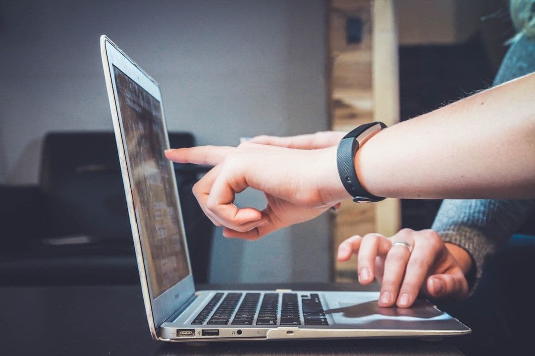 Recruiter reviewing resumes on computer screen