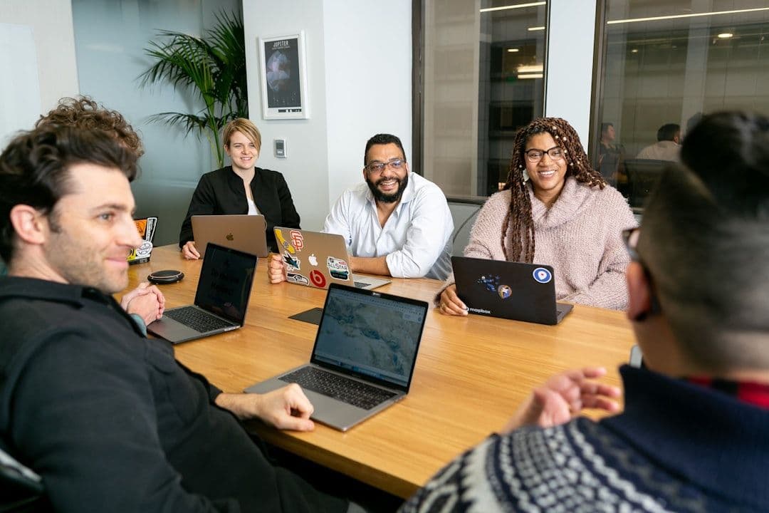 Diverse group of professionals in a meeting room discussing documents