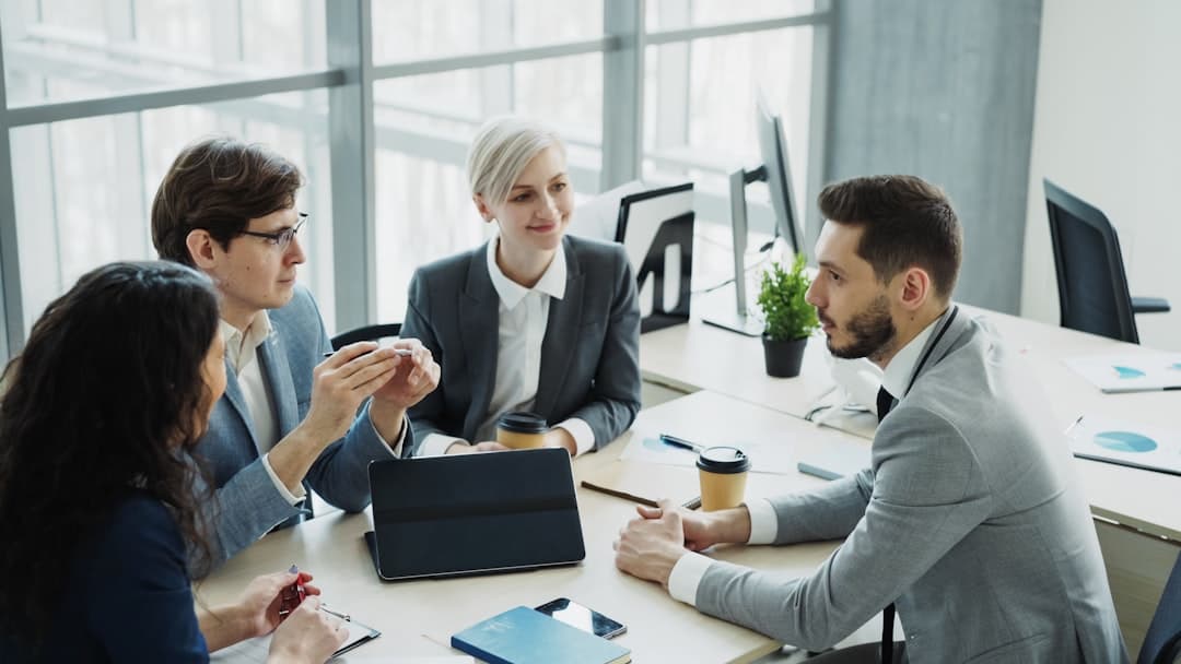 Professionals engaged in strategic discussion around a conference table
