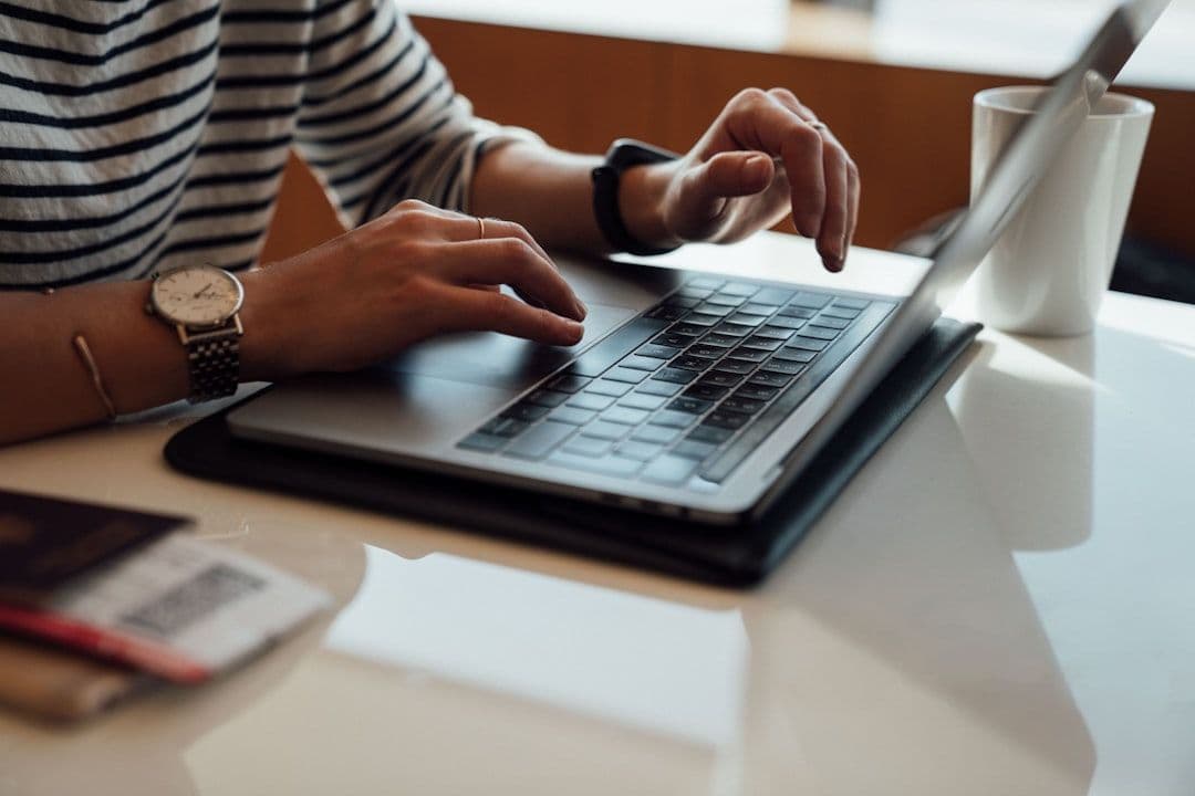 Professional researching company information on laptop