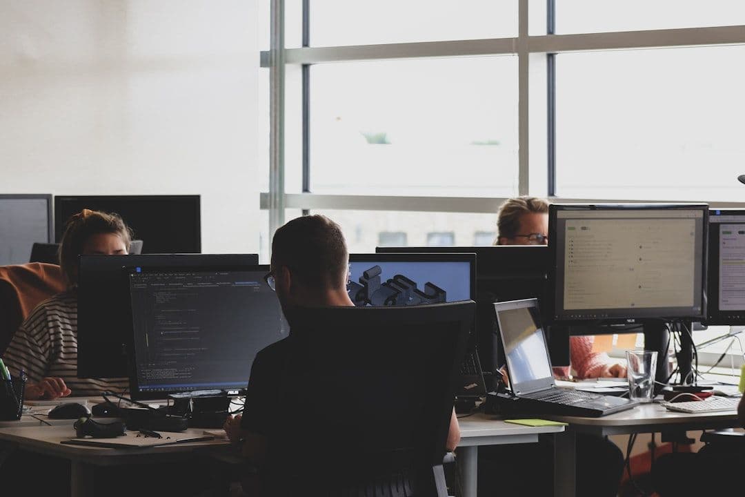 A cybersecurity analyst monitoring threat dashboards across multiple screens in a security operations center
