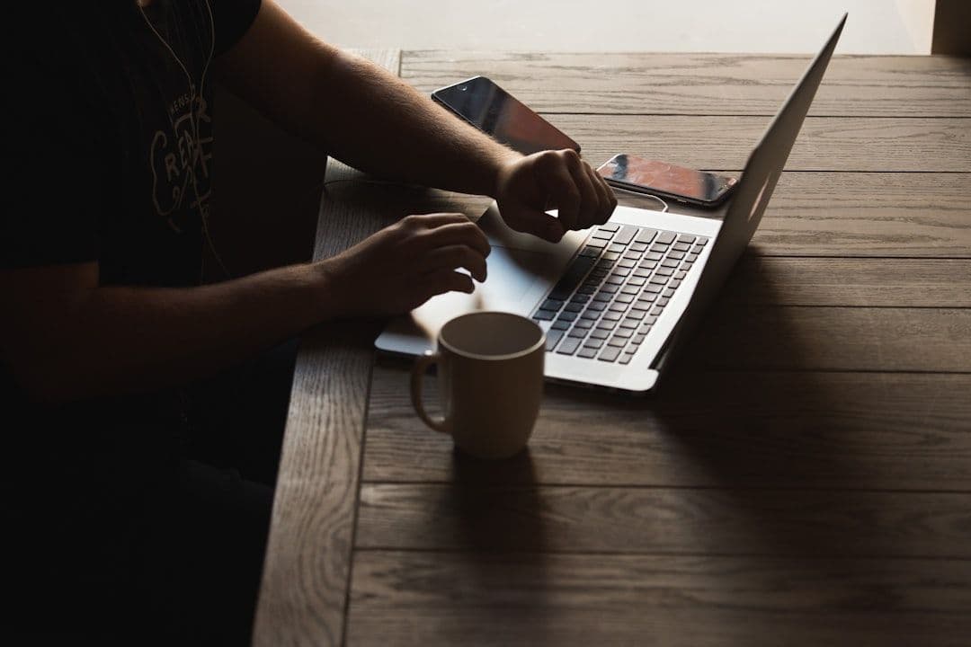 Freelancer working on a laptop at a coffee shop, representing gig economy work