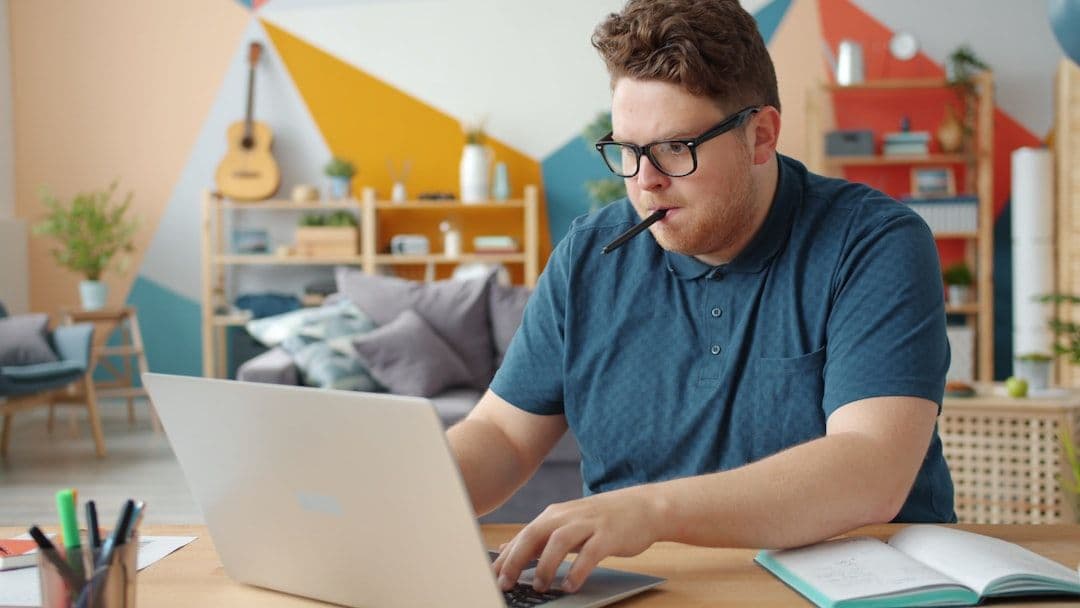 Person working remotely on a laptop at home, representing remote work location strategy