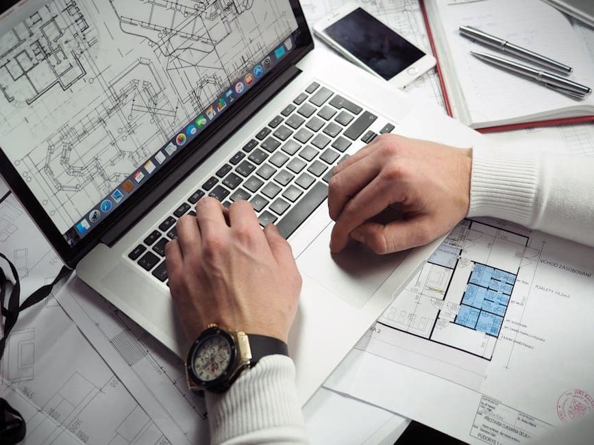 Construction manager working on project management software at a desk